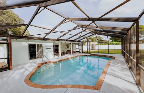 Palma Sola Casa | LUXE beach getaway 5mins from water. 3xKING BR, large heated pool + new playland