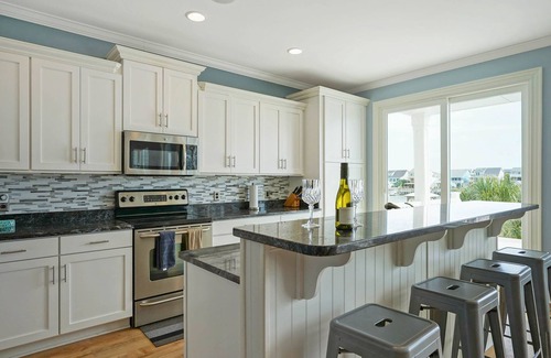 Sunset Beach Casa | Luxurious Sunset Beach Home On The Water With Pool, Boat Dock and Golf Cart