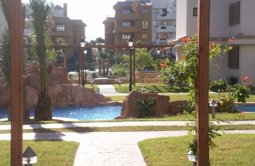 Punta Prima Apartamento | Apartamento de lujo de 2 dormitorios con gran terraza, 3 piscinas, cerca de la playa.