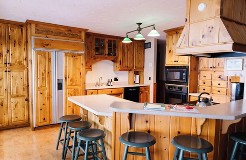 Nevis Casa | Luxury Lake Belle Taine retreat with private beach, sauna & four-season fun.