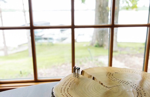 Nevis Casa | Luxury Lake Belle Taine retreat with private beach, sauna & four-season fun.