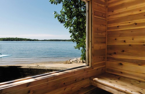 Nevis Casa | Luxury Lake Belle Taine retreat with private beach, sauna & four-season fun.
