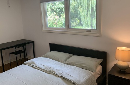 Rathwood Villa | Master bedroom with picturesque view to backyard and ravine