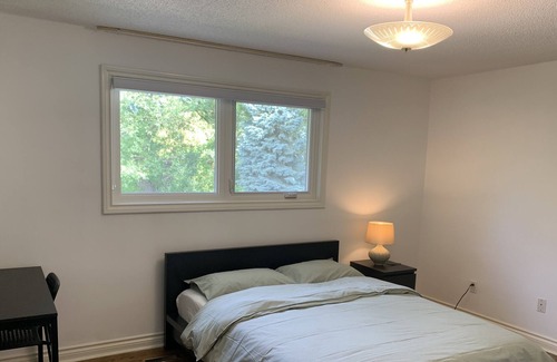 Rathwood Villa | Master bedroom with picturesque view to backyard and ravine