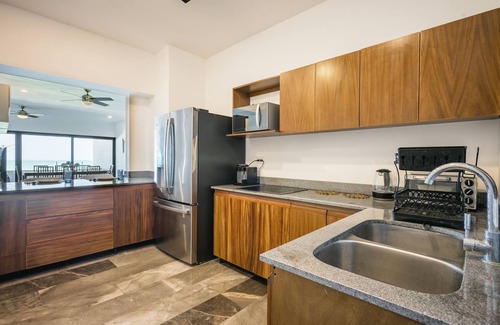 Ixil Apartamento | Oceanfront retreat with private balcony, outdoor pool, and stunning views