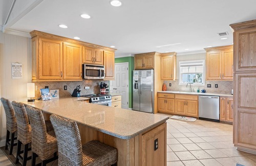 Ocean Isle Beach Casa | OIB Canal Home - GREAT outdoor - under house & screen porch, LARGE kitchen, DOCK