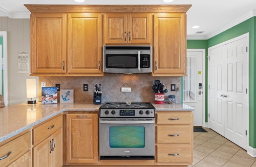 Ocean Isle Beach Casa | OIB Canal Home - GREAT outdoor - under house & screen porch, LARGE kitchen, DOCK