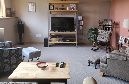 Pickett Casa | One bedroom and full bath in home 2 miles from EAA. Area with TV & refrigerator.