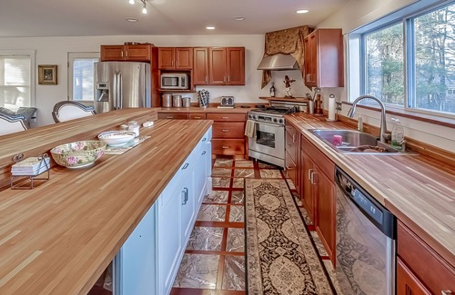 Belfast Casa | Ornate lake view home with wraparound deck, dock access & W/D