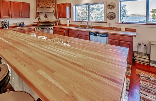 Belfast Casa | Ornate lake view home with wraparound deck, dock access & W/D