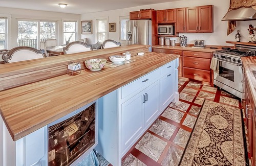 Belfast Casa | Ornate lake view home with wraparound deck, dock access & W/D