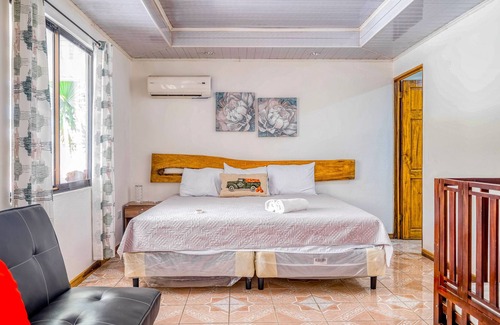 Garabito Casa | Palm-lined paradise with a pool, wood stove, & mountain views - dog-friendly