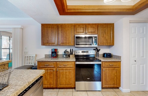 Pebble Beach Casa | Palm-lined waterfront retreat with enclosed pool, inviting patio, & central AC
