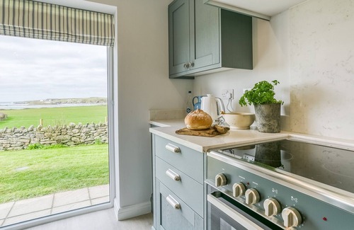 Ty Croes Cabaña | Penrhyn Isa Un - an on the beach that sleeps 6 guests in 3 bedrooms