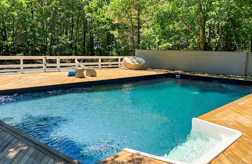 Quogue Casa | Post-Modern-style home with coastal-style bedrooms, an open-floor plan, a...
