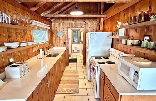 Traverse City Cabaña | Renovated Traverse City Lake House with Private Frontage & Sunset Views, Kayaks