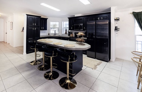 Weeki Wachee Gardens Casa | River home with huge arcade, hot tub kayaks, mini golf and floating pad, 80in TV