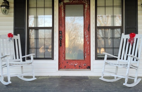 Peach County Casa | Rocking Chair front porch looking out on sprawling pecan trees filled w/ nature.