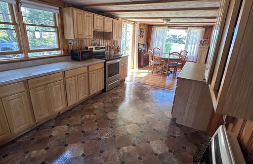 Northwood Casa | Rustic Lake front cottage nestled in the pines with a Golf Putting Green.
