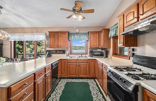 Bellaire Casa | Rustic lakefront home with large balcony, wood fireplace, grill, & washer/dryer