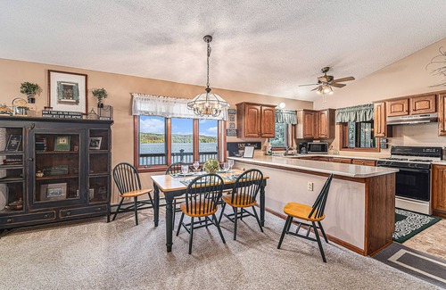 Bellaire Casa | Rustic lakefront home with large balcony, wood fireplace, grill, & washer/dryer