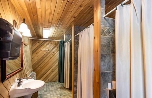 Neillsville Cabaña | Shared bunkhouse with individual private rooms with separate toilets and showers for men and women
