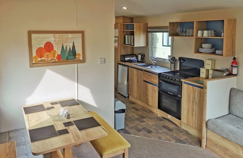 Llanllwchaiarn Casa | Spacious and well presented, 12-ft wide caravan with one double and one twin bedroom.