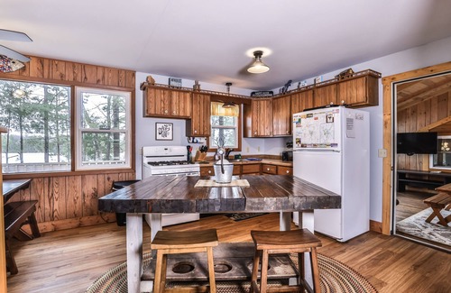Three Lakes Casa | Splendid lakefront home with deck, private W/D, fireplace, and patio area