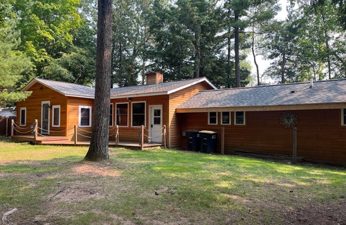 Three Lakes Casa | Splendid lakefront home with deck, private W/D, fireplace, and patio area