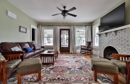 Historic District Casa | Storybook home with wrap around porch and deck