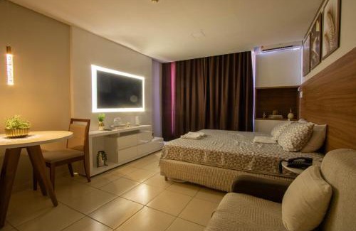 Caminho das Arvores Apartamento | Suíte luxo com tela de cinema no América Towers Studio Residence