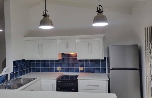 Dickenson Bay Apartamento | Swimming Pool- Balcony/Veranda- Sea & Sunset Views