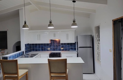 Dickenson Bay Apartamento | Swimming Pool- Balcony/Veranda- Sea & Sunset Views
