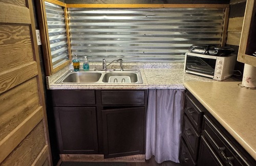 Pineville Cabina | The Little Sugar Shack, a rustic tiny cabin with hot tub access & fiery sunsets!