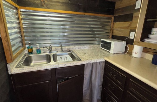 Pineville Cabina | The Little Sugar Shack, a rustic tiny cabin with hot tub access & fiery sunsets!