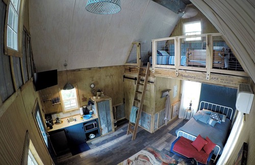 Mentone Cabaña | The Treehouses on wooded acreage that overlook a large lake.