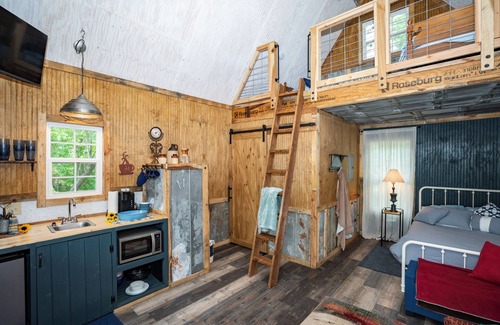 Mentone Cabaña | The Treehouses on wooded acreage that overlook a large lake.