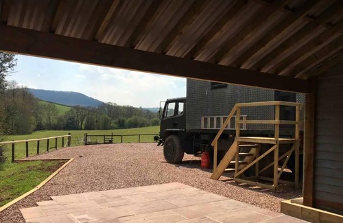 Usk Casa | Unique stay in your very own army truck. Sleeps 4. Hot tub. Tranquil setting.