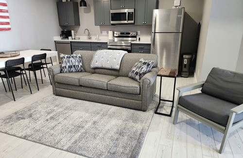 Mancelona Condominio | Unpack and relax with a Mountain view. New! Sleeps 6 Pools, New construction.