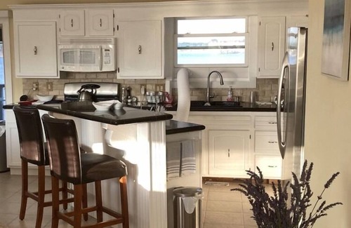 Ludington Casa | Upper level rental with large family room and huge wrap around deck full kitchen