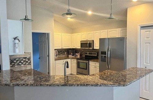 The Villages Casa | Premier home with Heated Pool, Waterfront, 2 king beds & 4 person golf cart.