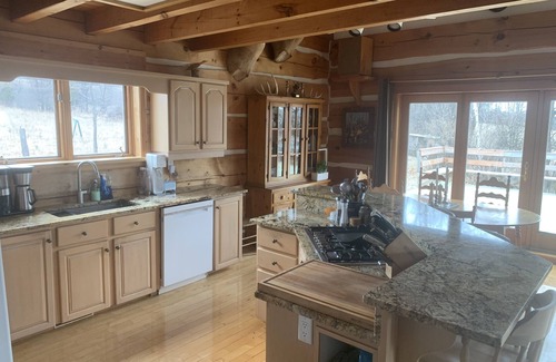 North Algona Wilberforce Cabaña | Waterfront log home on Lake Dore. Decks, dock, outdoor hot tub and fire pit.