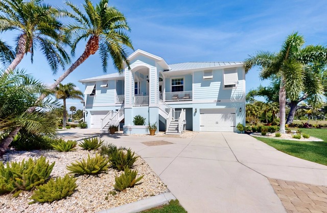 Canal-side monthly rental with private dock, heated pool, kayaks, & beach access