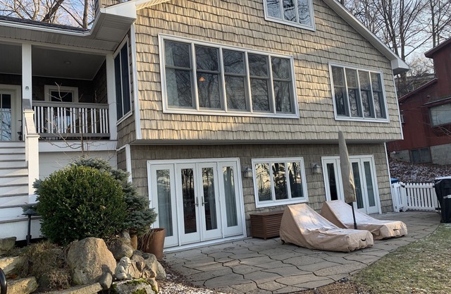 Charmer with lake views, hot tub, fire pit, and short walk to private beach.