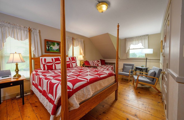 Comfortable room with queen bed and daybed with windows on 3 sides, a stunning view of Mount Mansfield and a parlor stove with full service breakfast included