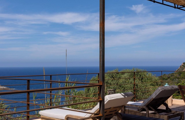 House between sea and scrubland near Arone beach in Piana, Corsica