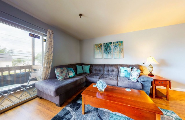 Inviting condo in quiet locale with partial lake views, balcony & grilling area