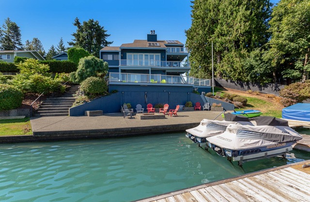 Peaceful lakefront home with firepit, hot tub, pool table, dock, balcony, & deck