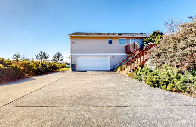 Peek-a-boo ocean view home with outdoor living space, W/D, and balcony