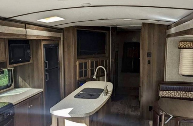 Private camp site on Sand Pond, nicely furnished RV & your own private dock!!
